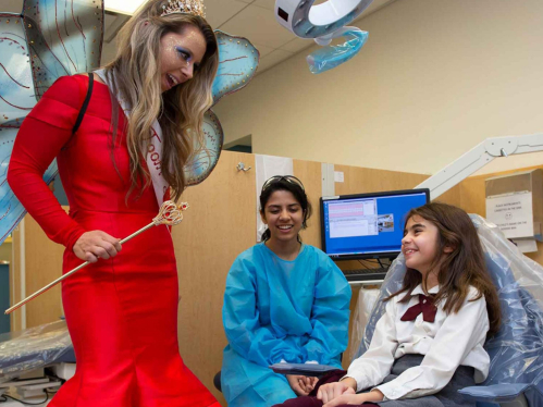 rutgers health student dentist cheering up a young patient