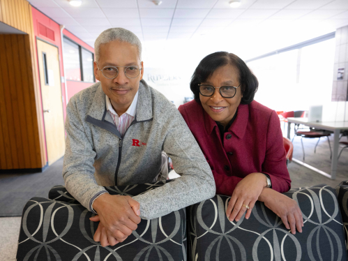 Darren Clarke and Saundra Tomlinson-Clarke leaning over the back of a couch