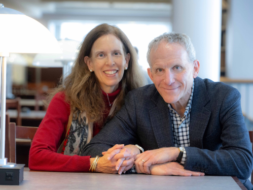 Amy and Jay Soled sitting together in a library