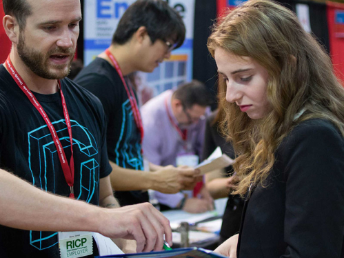 student receiving feedback on resume at career fair