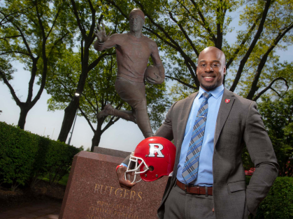 Shawn Tucker holding a football helmet