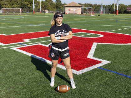 Allison Gandlin, a sophomore at Rutgers University-New Brunswick, stands on a sports field on Busch campus.
