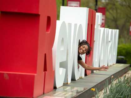 Camryn Harrell waves from inside one of the letters at the Revolutionary monument on Busch campus