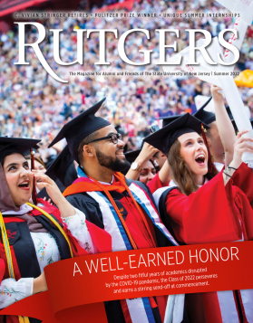 Three students celebrate during the Rutgers 2022 Commencement