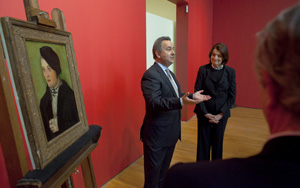 Simon Goodman accepts on behalf of his family the return of a rare Renaissance portrait from Suzanne Delehanty, director of the Zimmerli Art Museum.