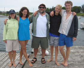 Gabriel standing alongside his family on a boardwalk