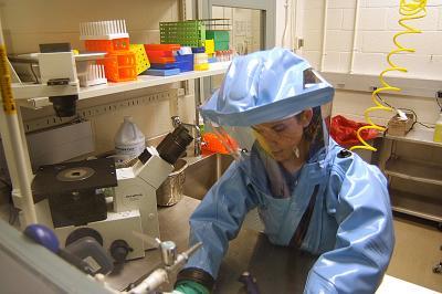 Med analyst in biosafety suit