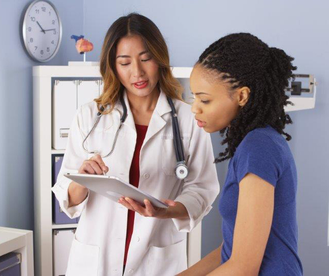 Image of physician with African-American adolescent girl