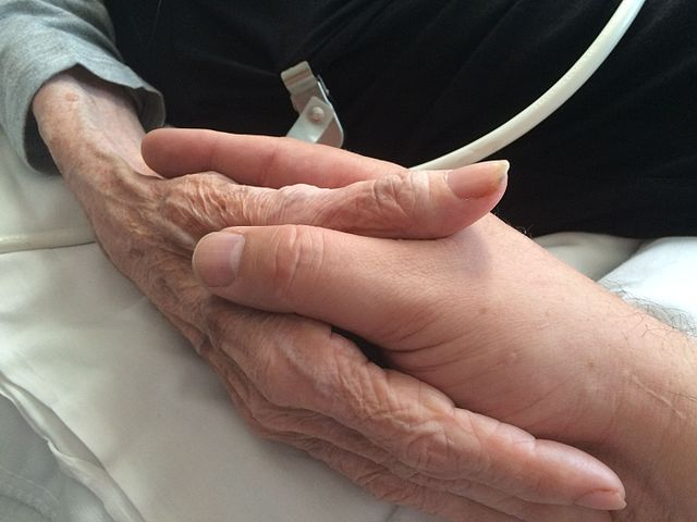 holding hands in hospice