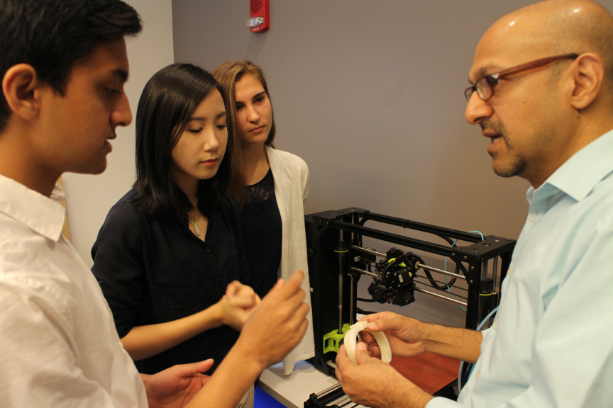 Patel and 3 students in the Innovation Lab.