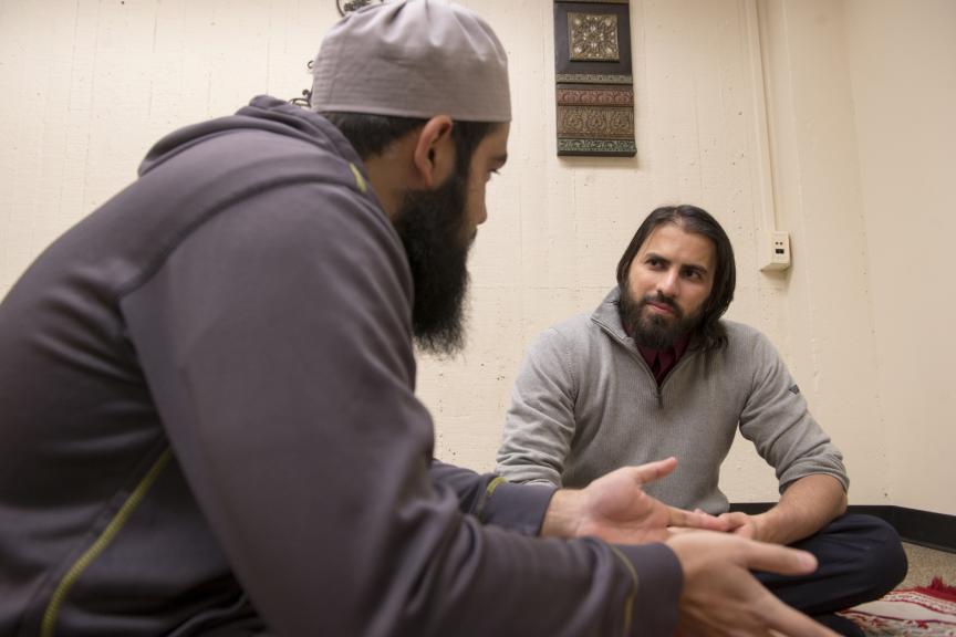 Rutgers student Hasan Usmani talks with Muslim chaplain Kaiser Aslam.