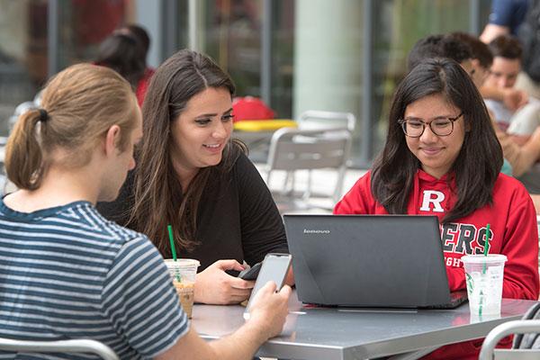 Rutgers Today, Rutgers news - Rutgers Selects Canvas as Official Learning Management System, Rutgers students use a laptop outdoors
