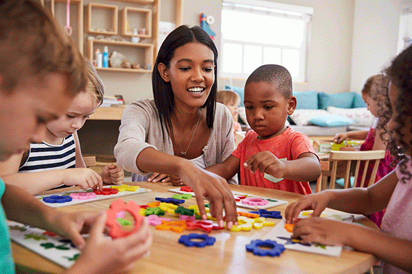 Rutgers Today, Rutgers news - New Report Gives Pre-K Policymakers the Building Blocks for School Success, group of preschool children learning shapes and colors with their preschool teacher