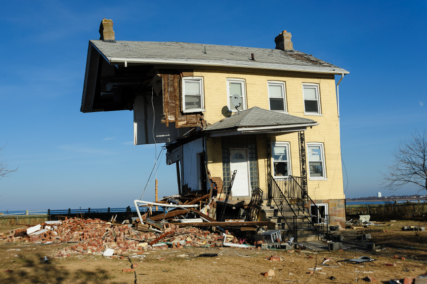 A tan-colored house that has been knocked in half due to Superstorm Sandy