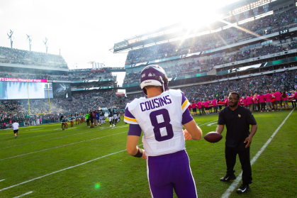 Terrell Barnes tossing a football with quarterback Kirk Cousins