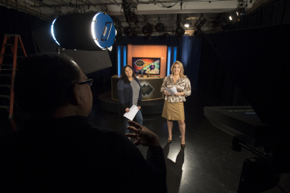 Executive Series Producer William Sanchez (NCAS '76), from left, directs graduate student Alice Hernandez (SMLR'18), and cohost Ebby Antigua on set for a taping of Images/Imágenes. 