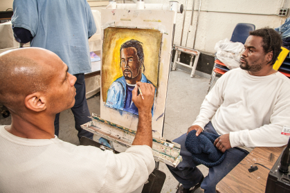 Ronnie Goodman paints a fellow inmate at San Quentin State Prison in California