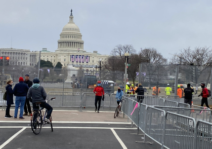 People gathering around fenced in areas 