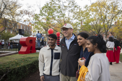 Holloway poses with students