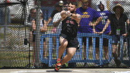 Jude Misko hurling a 16-lb. metal ball