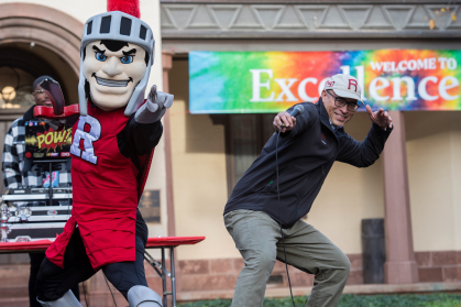 President Holloway has some fun with the Scarlet Knight on stage at Excellence Fest, which took place on November 4 in front of Bishop House located on the College Avenue campus at Rutgers–New Brunswick.
