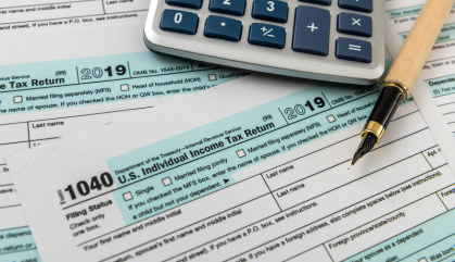 FORM 1040 taxes with calculator and pen 
