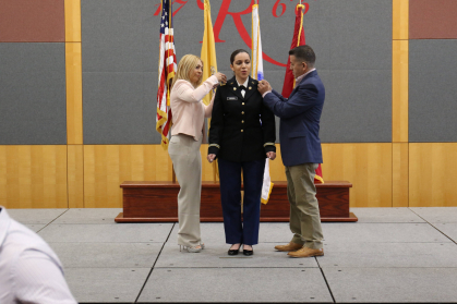 Second Lieutenant Denise Cornell being pinned by her parents