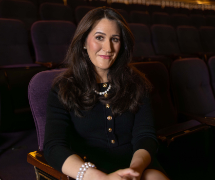 A woman sitting in a chair.