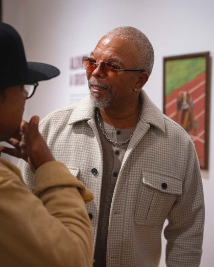 Alonzo Adams exchanges words during the opening reception for his exhibition, "Alonzo Adams: A Griot’s Vision," on Sept. 23 at the Zimmerli.