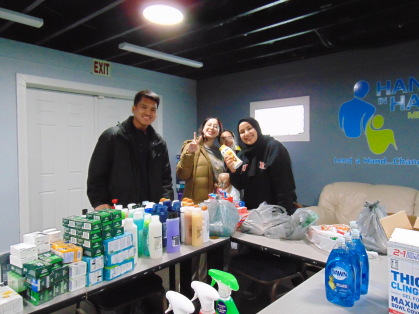 stdents bagging personal care items at Hand in Hand for distribution