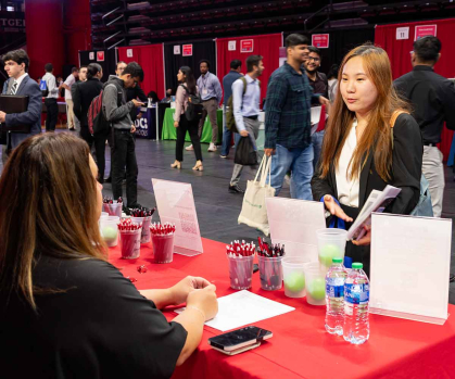 As attendee talks with a recruiter during the Fall 2023 Career and Internship Mega Fair at Rutgers University–New Brunswick.