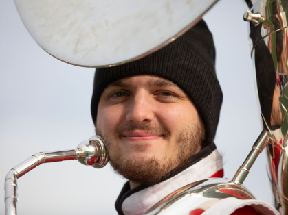 Senior Joe Marta plays sousaphone with the Scarlet Marching Knights and arranges some of their music.