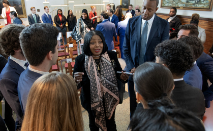 Racha Barlow, center, who was pardoned by New Jersey Gov. Phil Murphy during an event at Winants Hall, speaks to Rutgers students from Elie Honig’s New Jersey Clemency Internship on 4/8/25 in New Brunswick, N.J. Behind Barlow is Justin Dews, chair of Murphy’s Clemency Advisory Board.