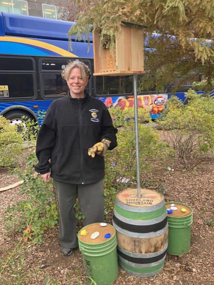 Rutgers professor Kimberly Russell stands in front of bee bunkers and hotels that she and her team designed.