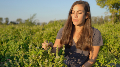 Lara Brindisi in a field with basil