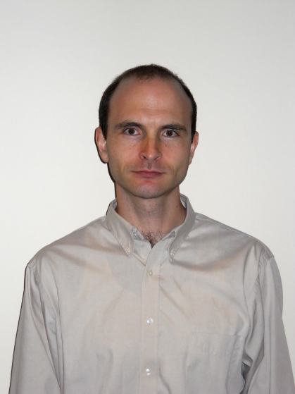 Male standing against a white background