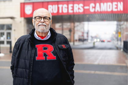 Cal Maradonna standing in front of a Rutgers Camden sign