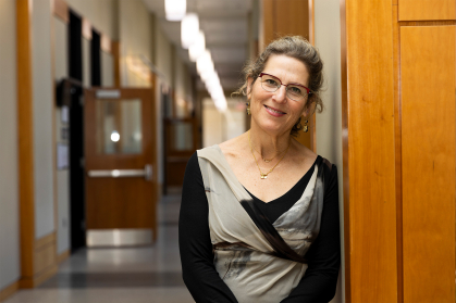 Ellen Goodman standing in a school buidling 