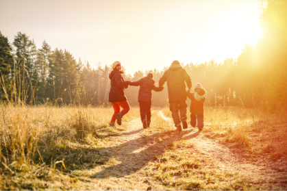 Family running on country road in autumn time