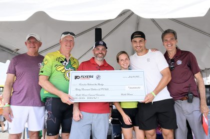 Flyers present a check to the foundation