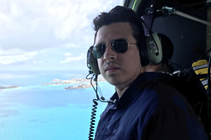 Joshua Hoyos with aerial view from helicopter