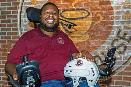 Eric LeGrand with logo of LeGrand Coffee House on New Jersey Devils helmet 