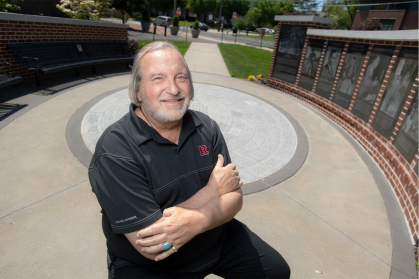 Jim Savage sitting in the Paul Robeson monument 