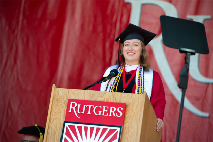 Allison Smith, president of the Rutgers University Student Assembly, staning at the podium addressing commencement