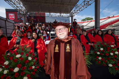 Pat Gardner standing with the choir at Commencement 