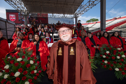 Pat Gardner standing with the choir at Commencement