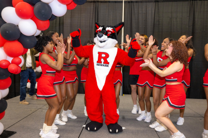The Rutgers Newark Cheer team welcomes the mascot