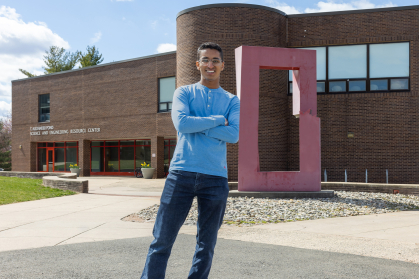 Tej Shah standing in front of the Science and engineering resource center