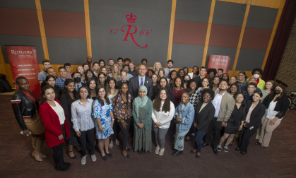 President Jonathan Holloway poses with students at the Rutgers Summer Service Internship Initiative launch event on May 19, 2022