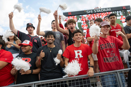 students cheering at a football game in the student section